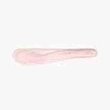 Dinosaur Designs Temple Cake Knife in Shell Pink — handcrafted marbled pale pink resin cake knife with smooth tapered blade and rounded handle.