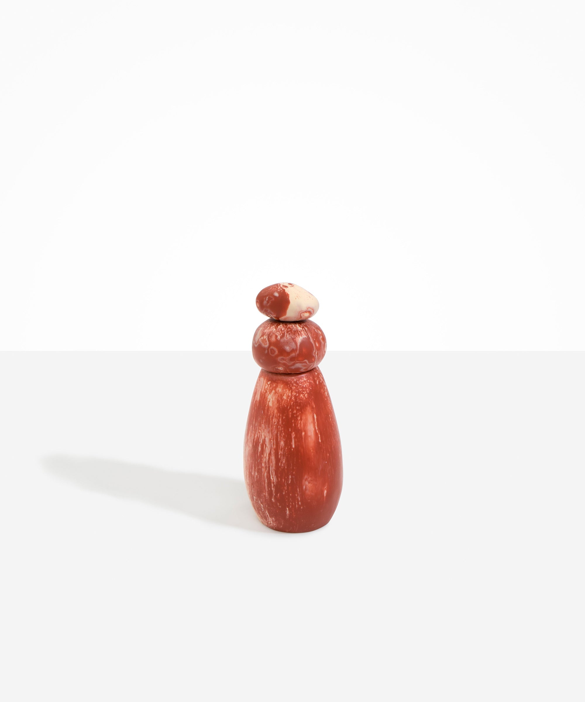 Dinosaur Designs Tall Pepper Boulder Grinder in Rust — handcrafted marbled terracotta red and cream resin pepper grinder with elongated teardrop body and stacked pebble lid