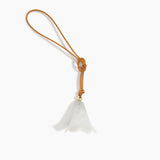 Dinosaur Designs Flower Bag Charm in Chalk Swirl colour with Brass bead — handcrafted marbled off-white resin bell-shaped flower bag charm with tan leather hanging loop and brass bead