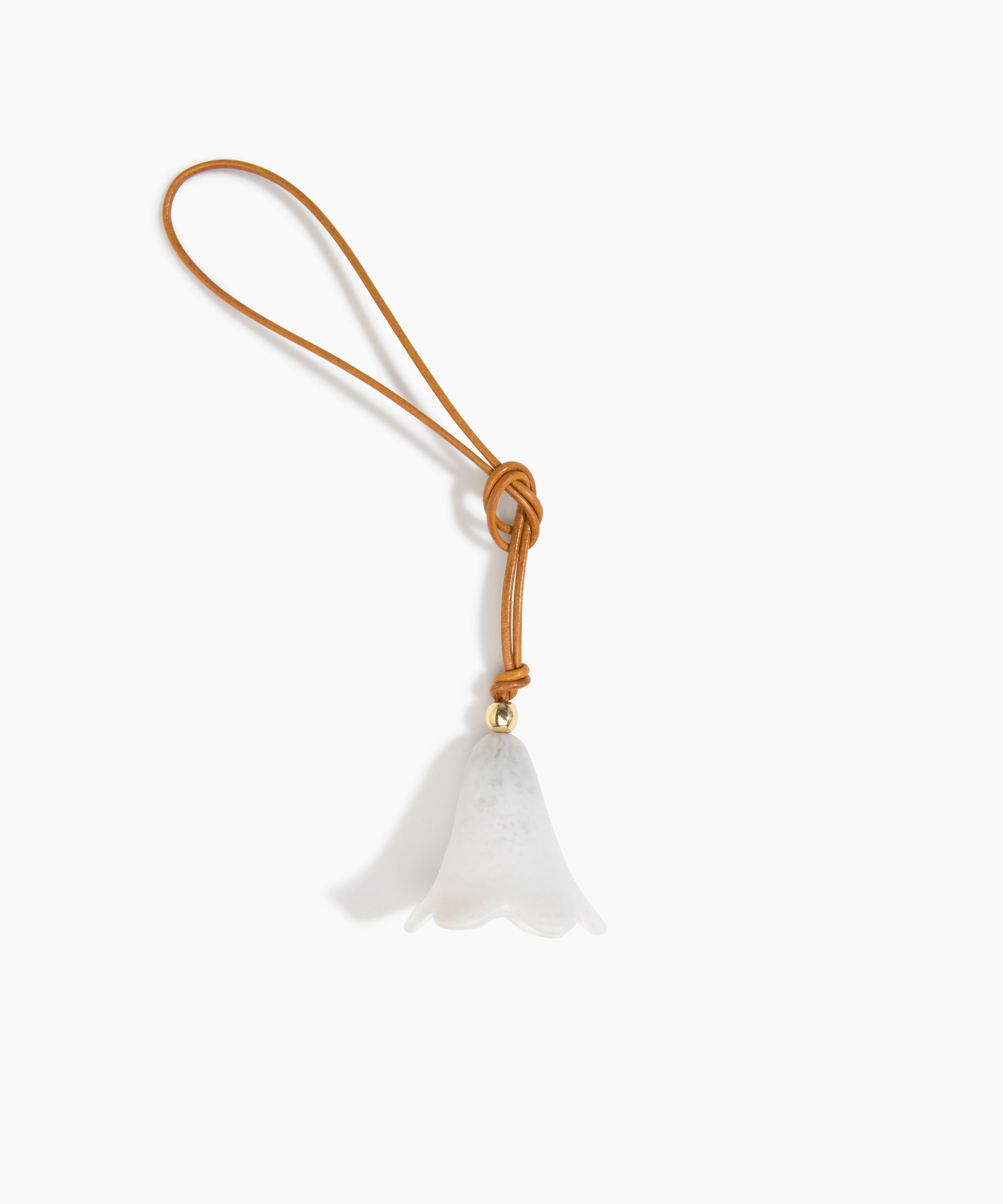 Dinosaur Designs Flower Bag Charm in Chalk Swirl colour with Brass bead — handcrafted marbled off-white resin bell-shaped flower bag charm with tan leather hanging loop and brass bead