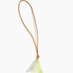 Dinosaur Designs Flower Bag Charm in Pistachio colour with Brass bead — handcrafted marbled pastel green resin bell-shaped flower bag charm with tan leather hanging loop and brass bead