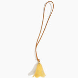 Dinosaur Designs Flower Bag Charm in Pollen colour with Brass bead — handcrafted marbled yellow resin bell-shaped flower bag charm with tan leather hanging loop and brass bead