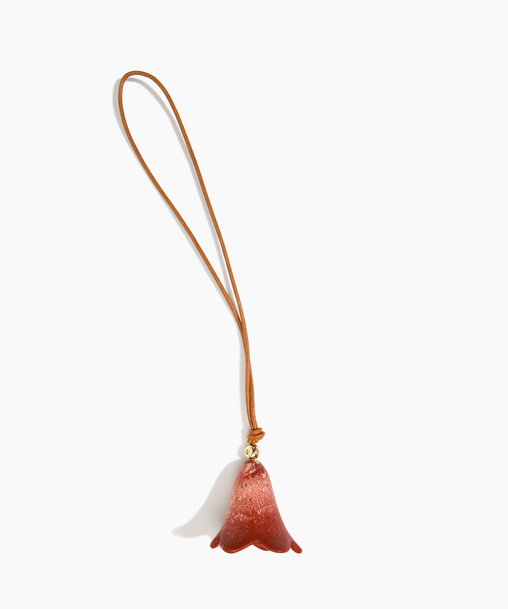 Dinosaur Designs Flower Bag Charm in Rust colour with Brass bead — handcrafted marbled terracotta red and cream resin bell-shaped flower bag charm with tan leather hanging loop and brass bead