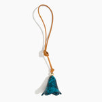 Dinosaur Designs Flower Bag Charm in Turquoise colour with Brass bead — handcrafted marbled teal blue resin bell-shaped flower bag charm with tan leather hanging loop and brass bead