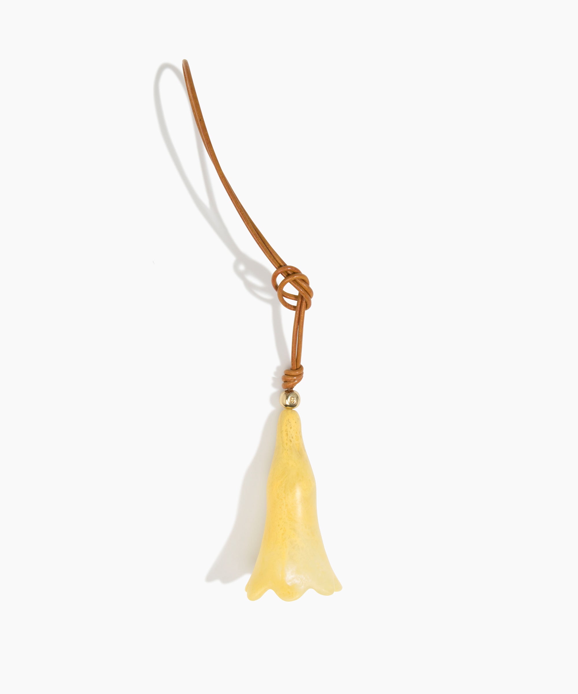 Dinosaur Designs Long Flower Bag Charm in Pollen colour with Brass bead — handcrafted marbled yellow resin bell-shaped flower bag charm with tan leather hanging loop and brass bead