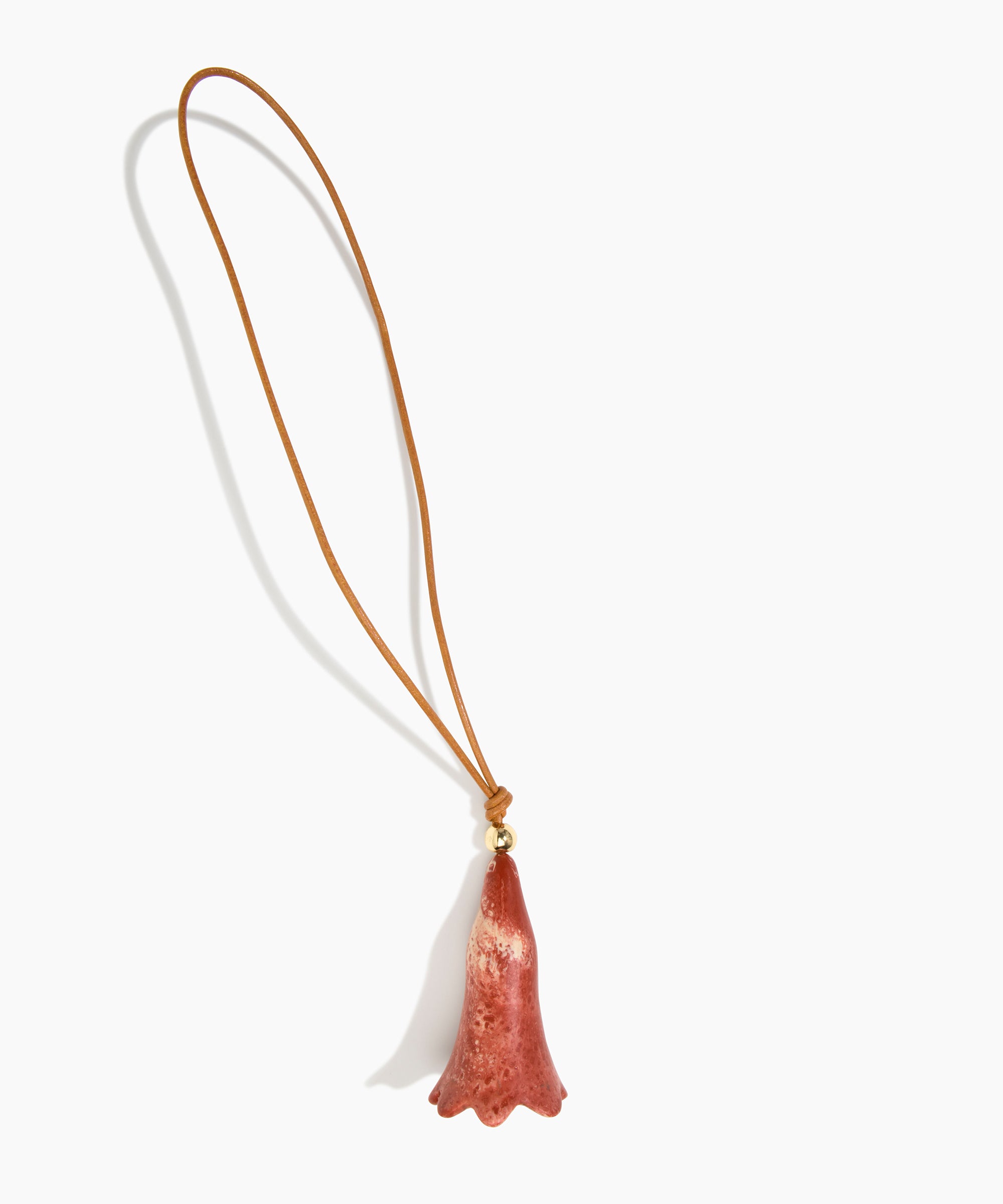Dinosaur Designs Long Flower Bag Charm in Rust colour with Brass bead — handcrafted marbled terracotta red and cream resin bell-shaped flower bag charm with tan leather hanging loop and brass bead