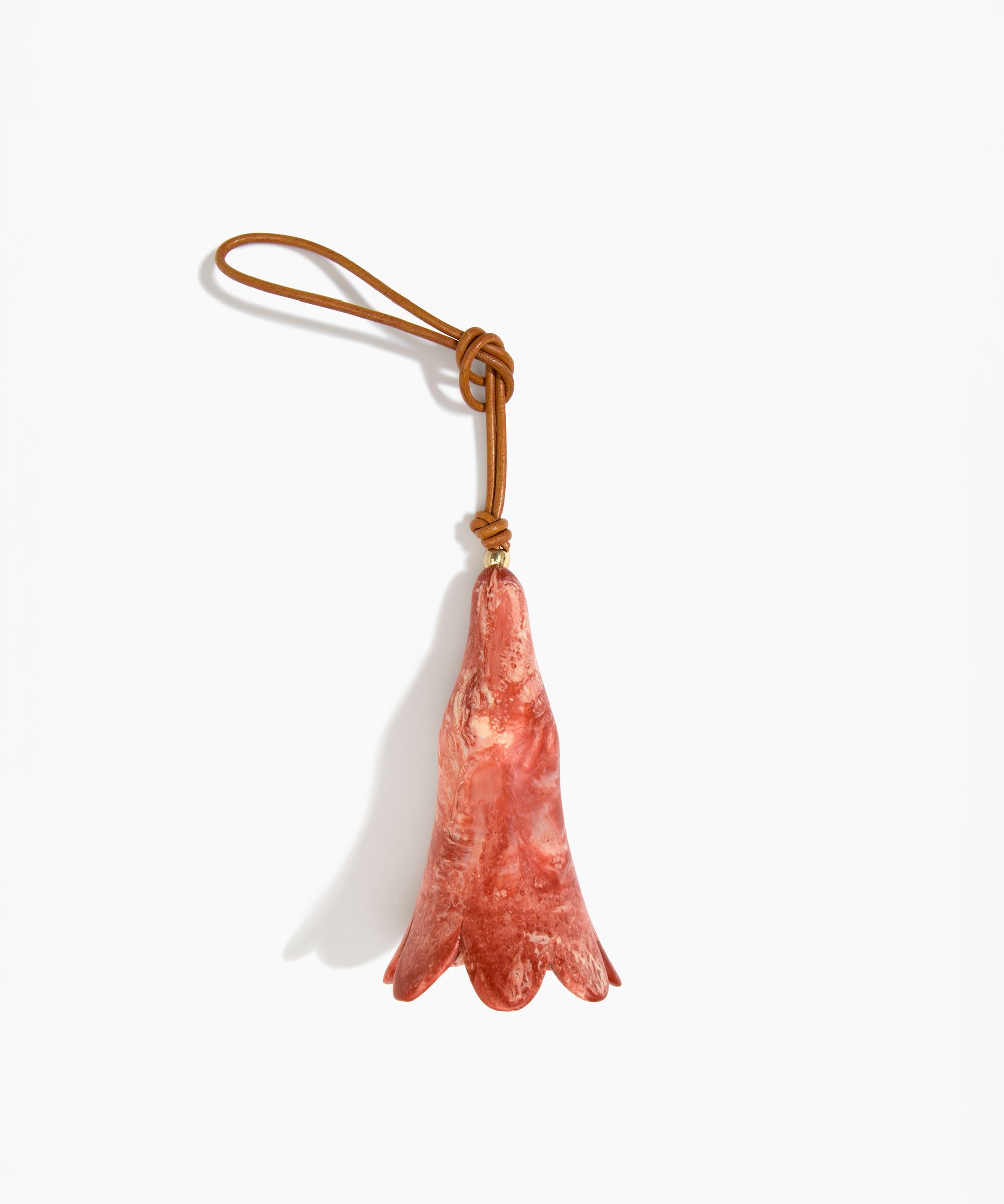Dinosaur Designs Long Flower Decoration in Rust colour with Brass bead — handcrafted marbled terracotta red and cream resin bell-shaped flower ornament with tan leather hanging loop and brass bead