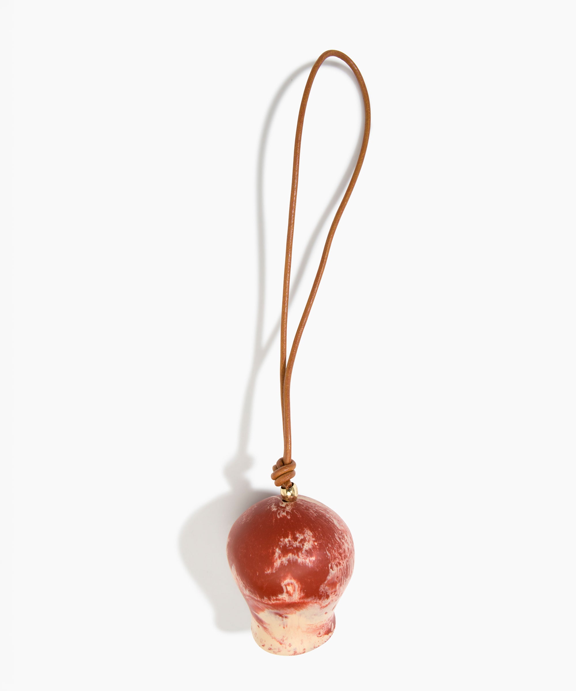 Dinosaur Designs Gumnut Decoration in Rust colour with Brass hardware — handcrafted marbled terracotta red and cream resin gumnut-shaped ornament with tan leather hanging loop and brass bead