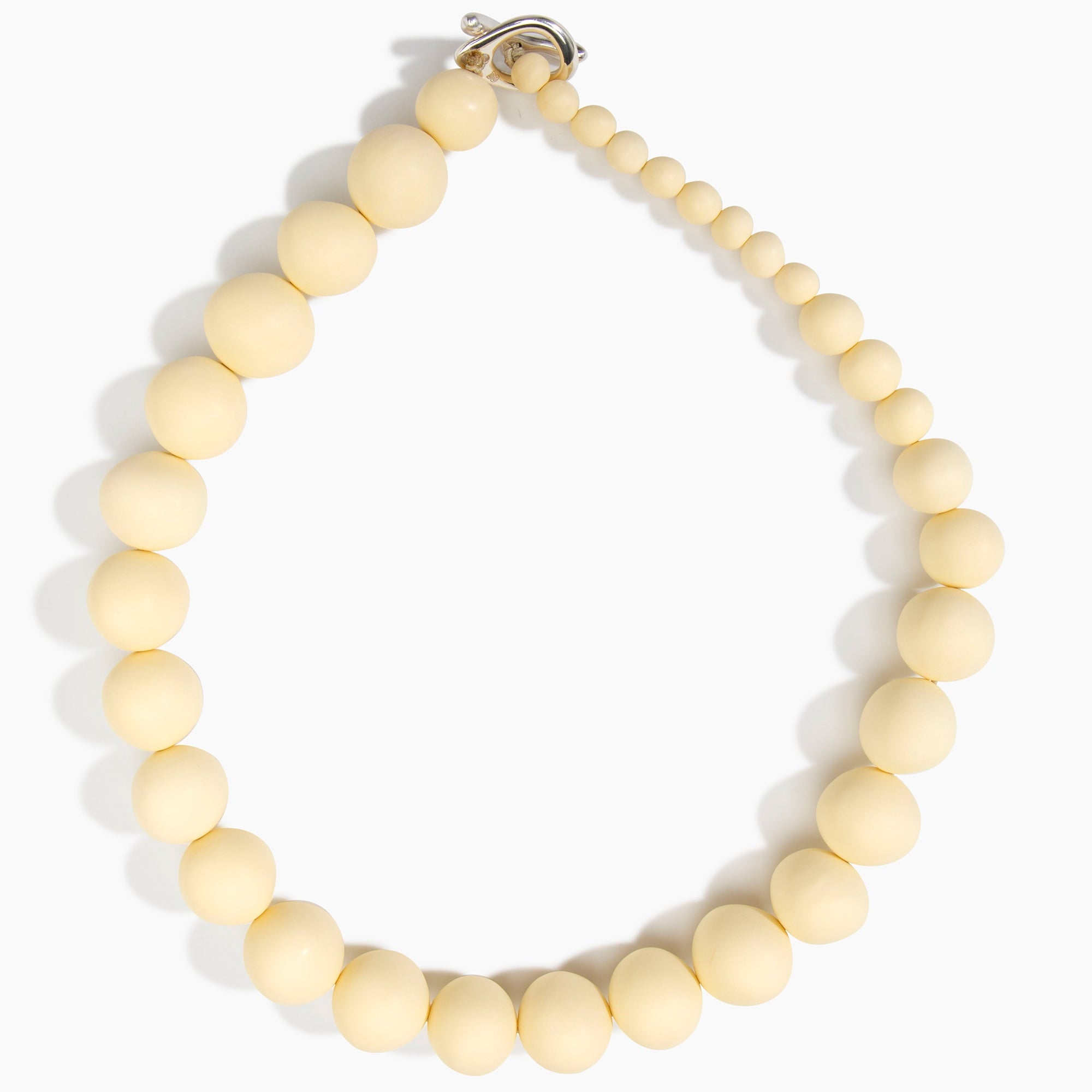 Dinosaur Designs Organic Ball Necklace in Cream — handcrafted marbled cream resin graduating bead necklace with silver t-bar clasp.