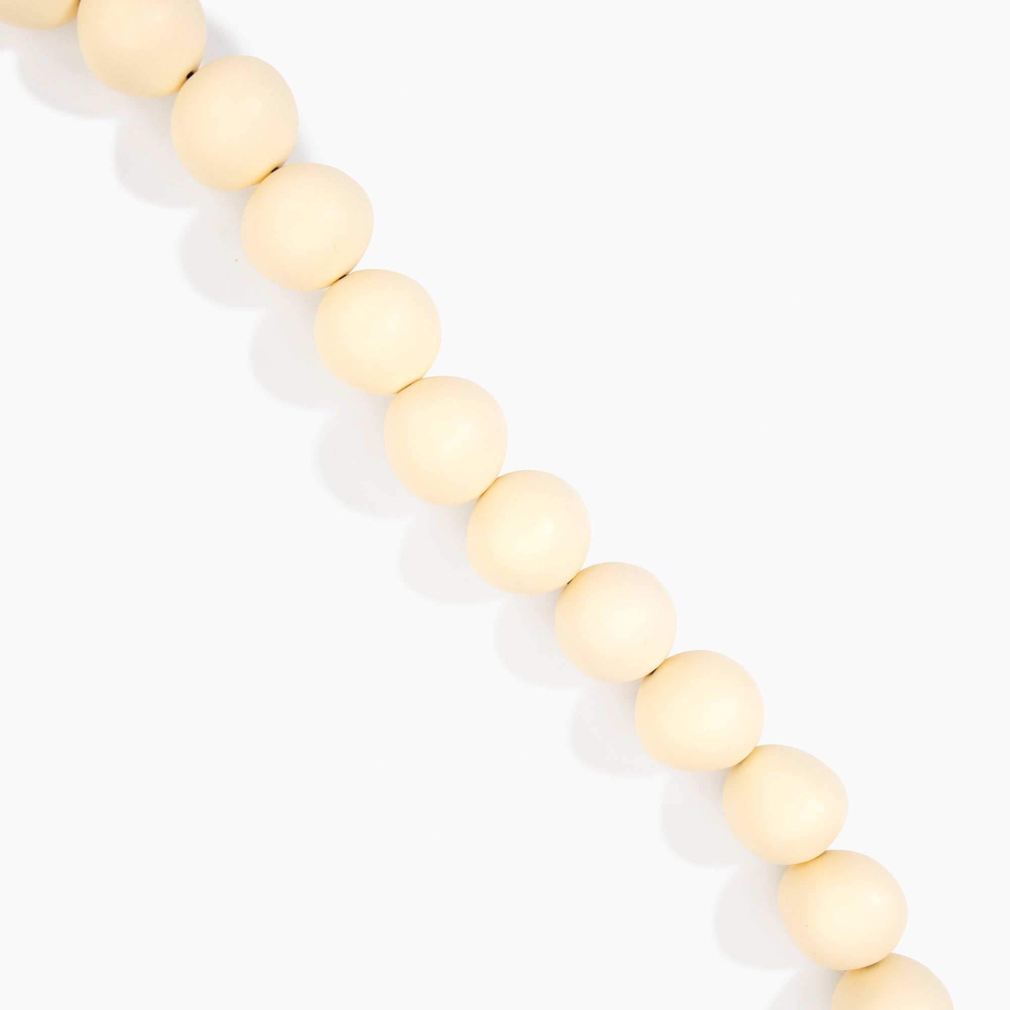 Dinosaur Designs Organic Ball Necklace in Cream — handcrafted marbled cream resin graduating bead necklace with silver t-bar clasp.