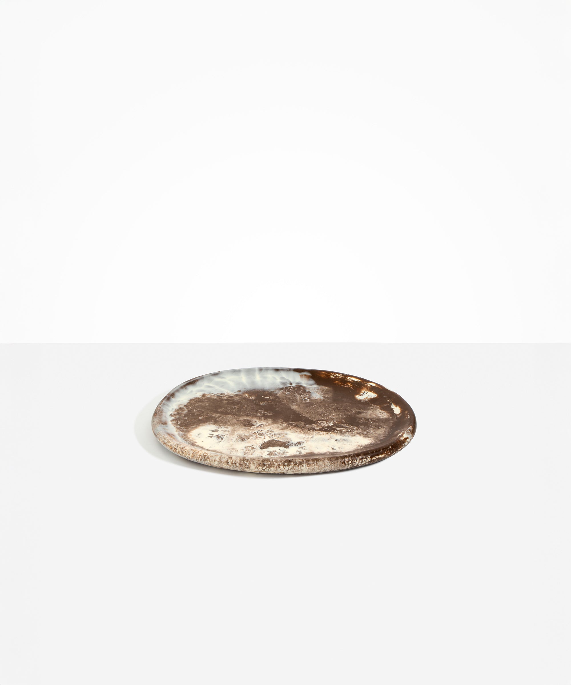 Dinosaur Designs Rock Plate in Cappuccino — handcrafted marbled brown and cream resin oval flat serving plate with rounded organic edge