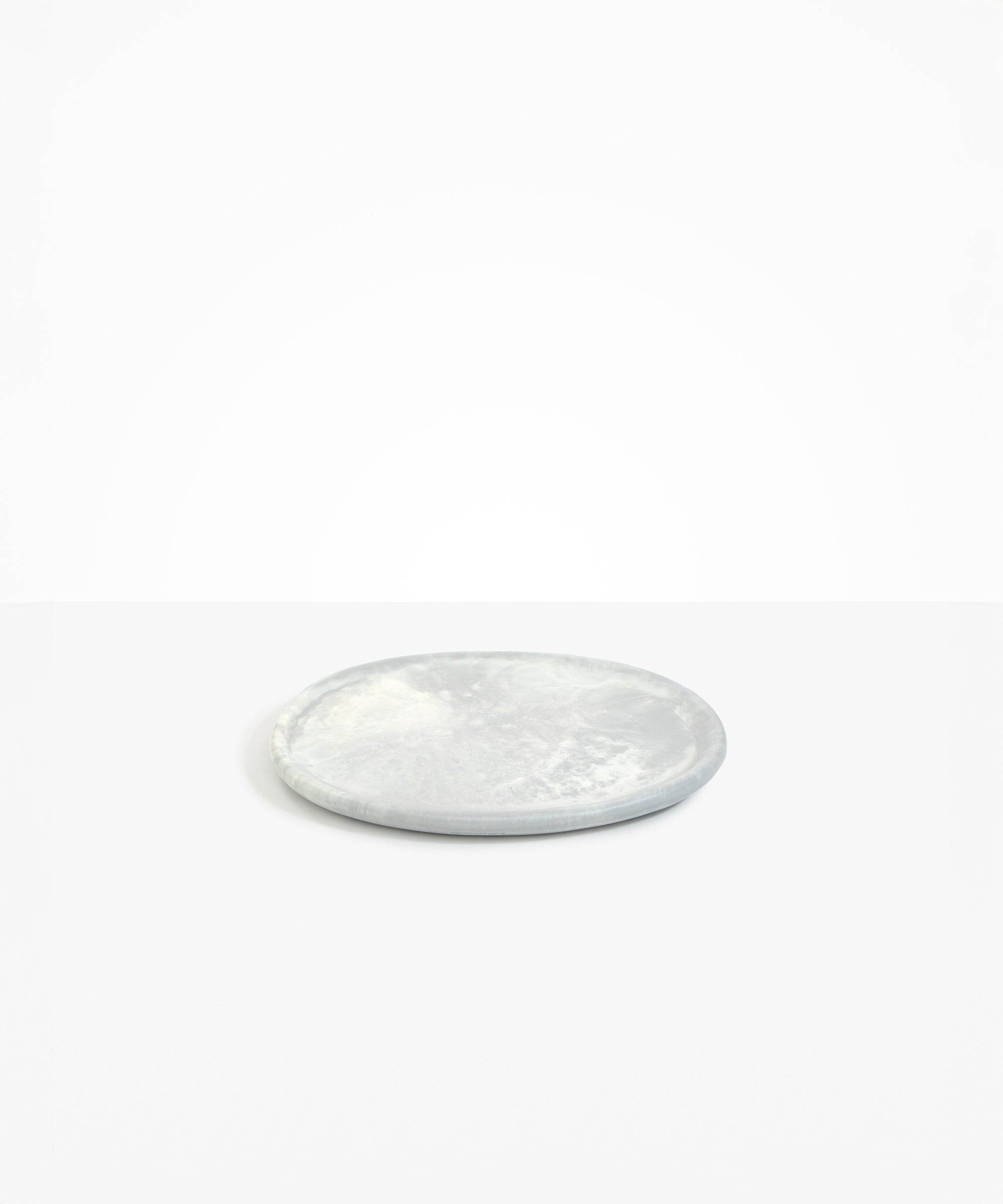 Dinosaur Designs Rock Plate in Cloud — handcrafted marbled grey and cream resin oval flat serving plate with rounded organic edge..