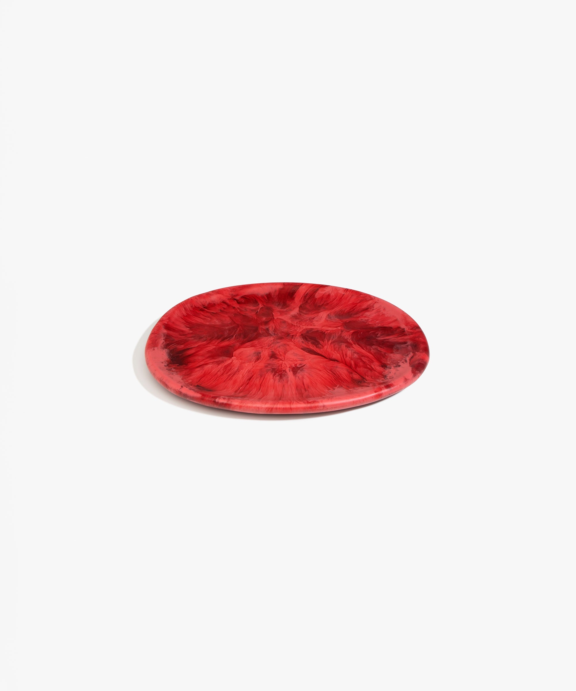 Dinosaur Designs Rock Plate in Cranberry — handcrafted marbled red resin oval flat serving plate with rounded organic edge