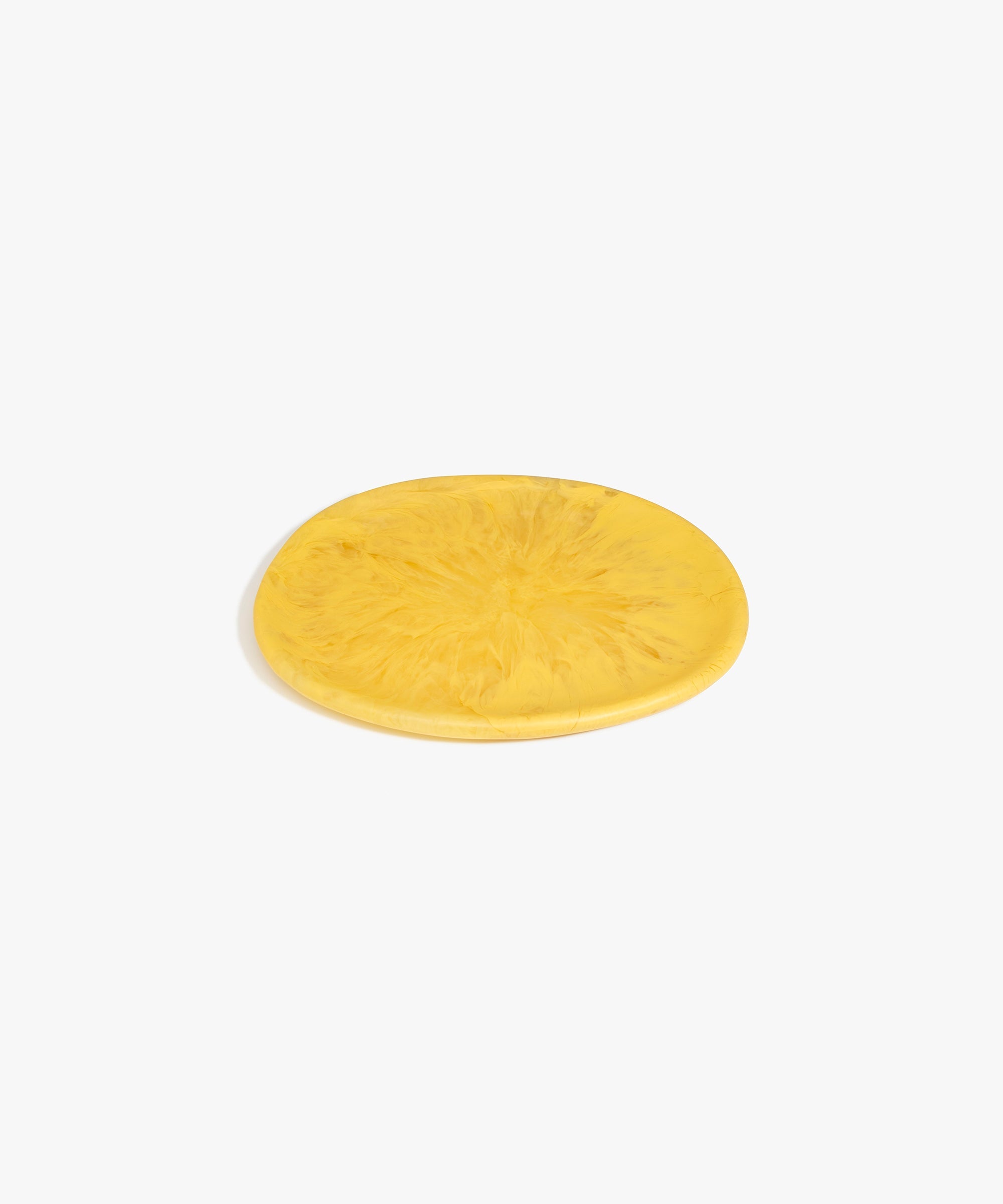 Dinosaur Designs Rock Plate in Pollen — handcrafted marbled yellow resin oval flat serving plate with rounded organic edge..