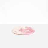 Dinosaur Designs Rock Plate in Shell Pink — handcrafted marbled pink resin oval flat serving plate with rounded organic edge..
