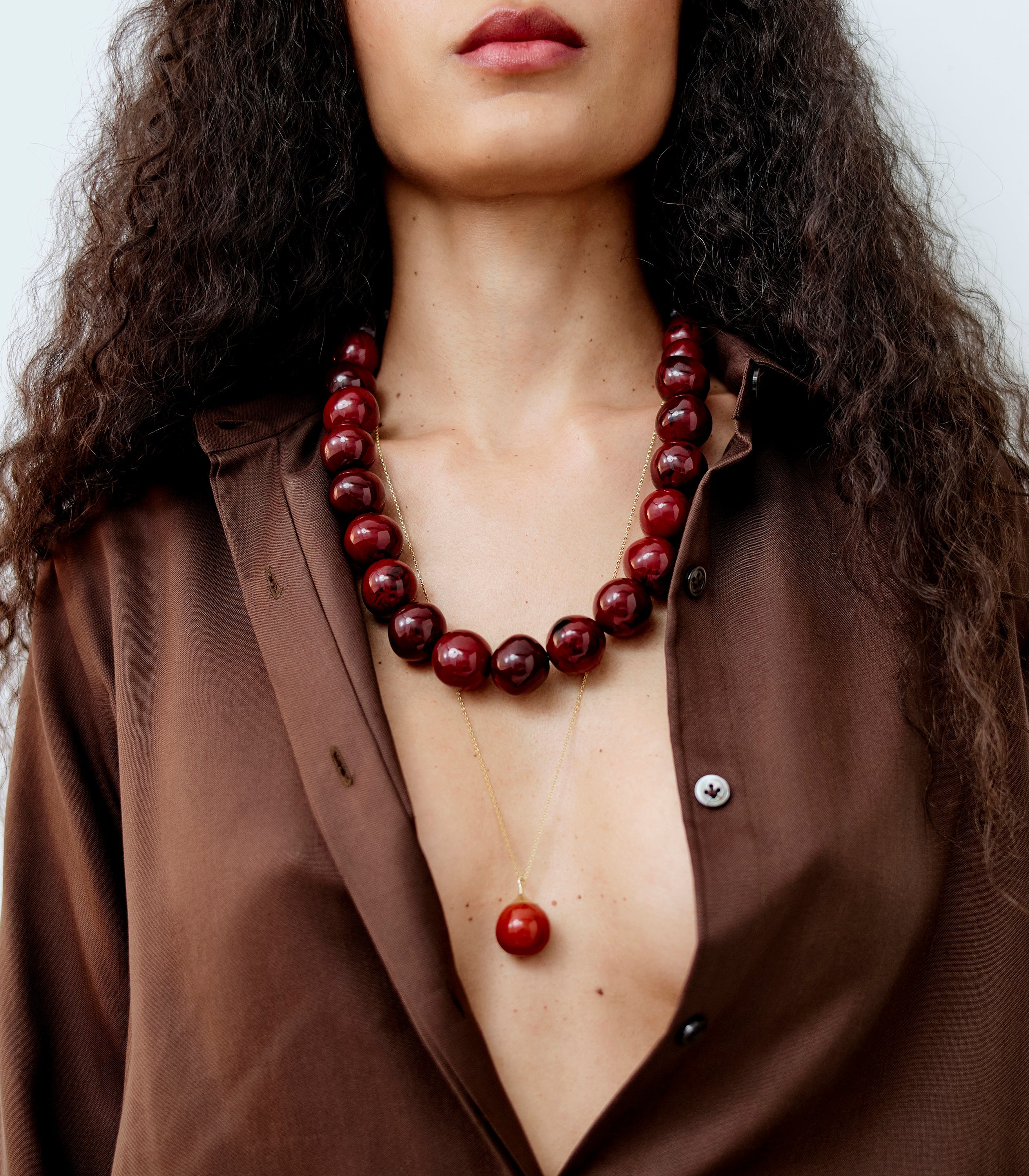 Dinosaur Designs layered coloured resin bead necklace with bead pendant in Crimson red