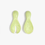 Dinosaur Designs Rock Servers in Pistachio — handcrafted marbled pale green resin salad server set with rounded bulb handles, fork and spoon.