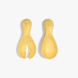 Dinosaur Designs Rock Servers in Pollen — handcrafted marbled yellow resin salad server set with rounded bulb handles, fork and spoon.
