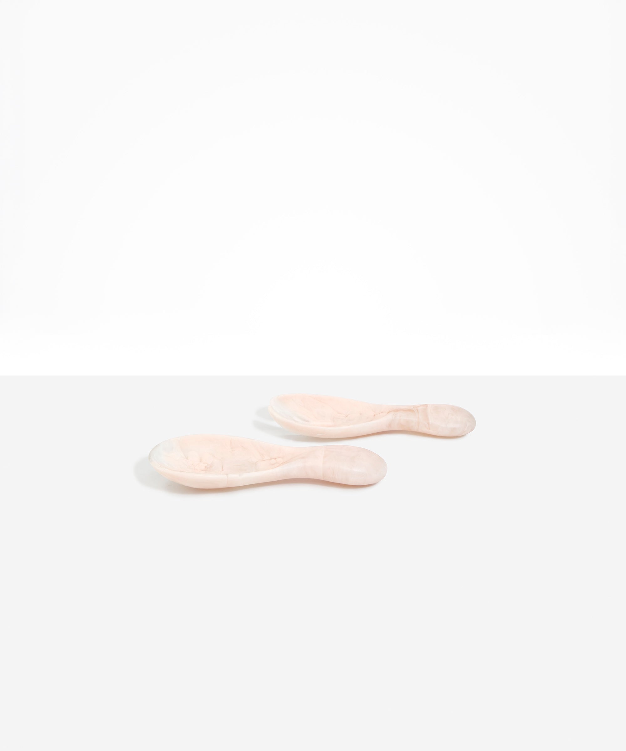 Dinosaur Designs Rock Servers in Rose Swirl — handcrafted marbled dusty pink resin salad server set with rounded bulb handles, fork and spoon.