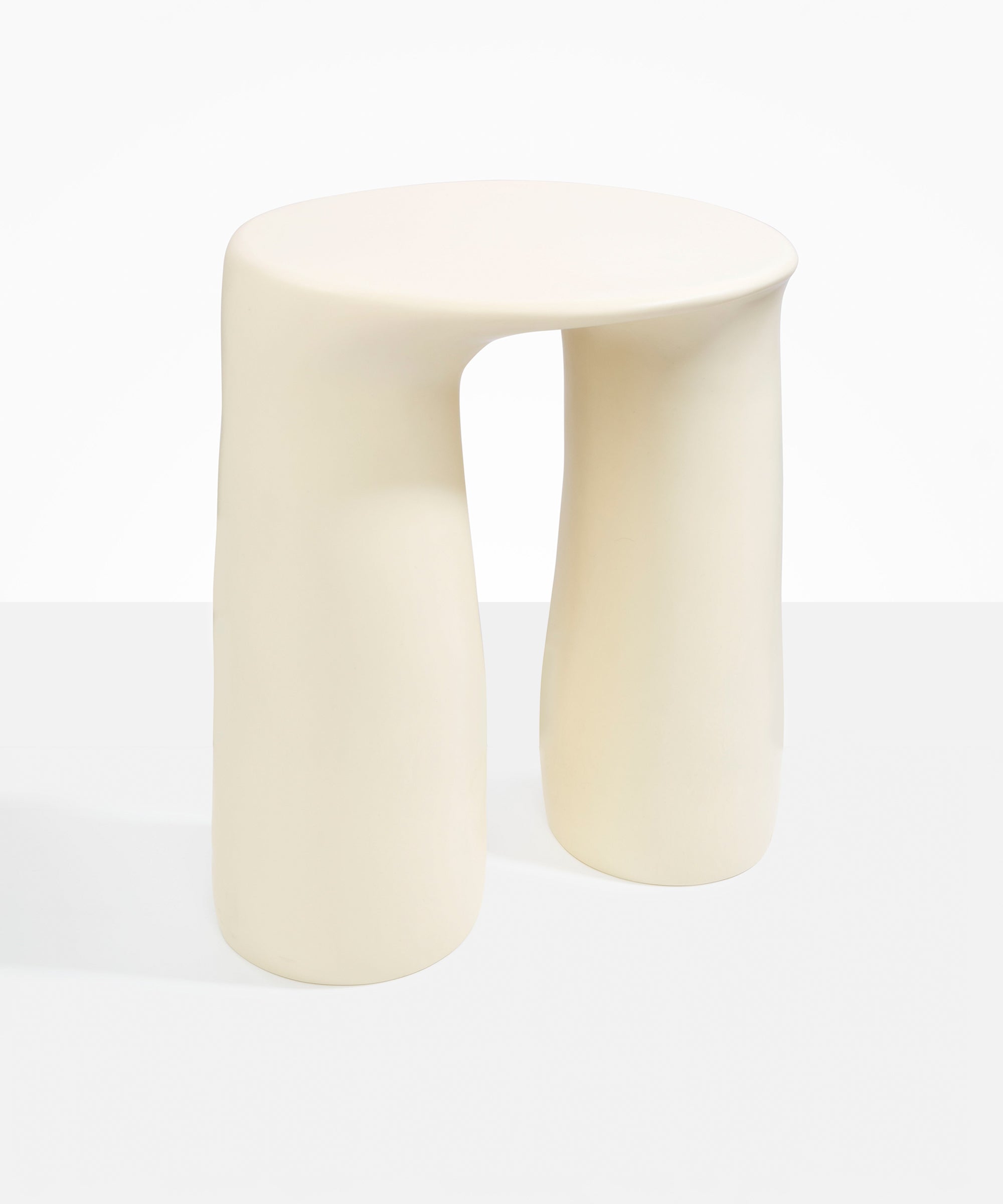 Dinosaur Designs Rock Tower Table in Cream — handcrafted cream resin side table with oval top and two chunky rounded legs..