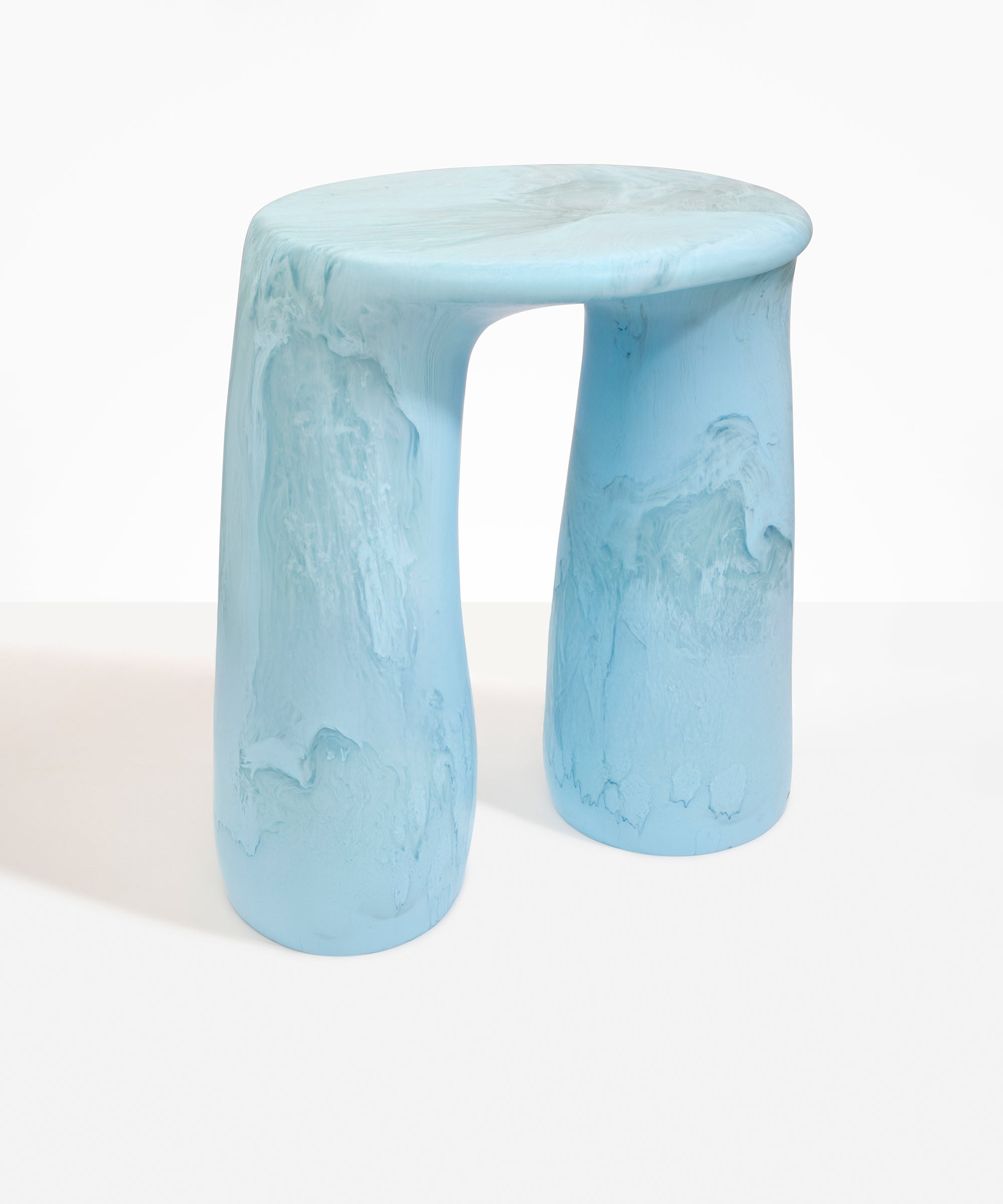 Dinosaur Designs Rock Tower Table in Pool — handcrafted marbled blue and clear resin side table with oval top and two chunky rounded legs..
