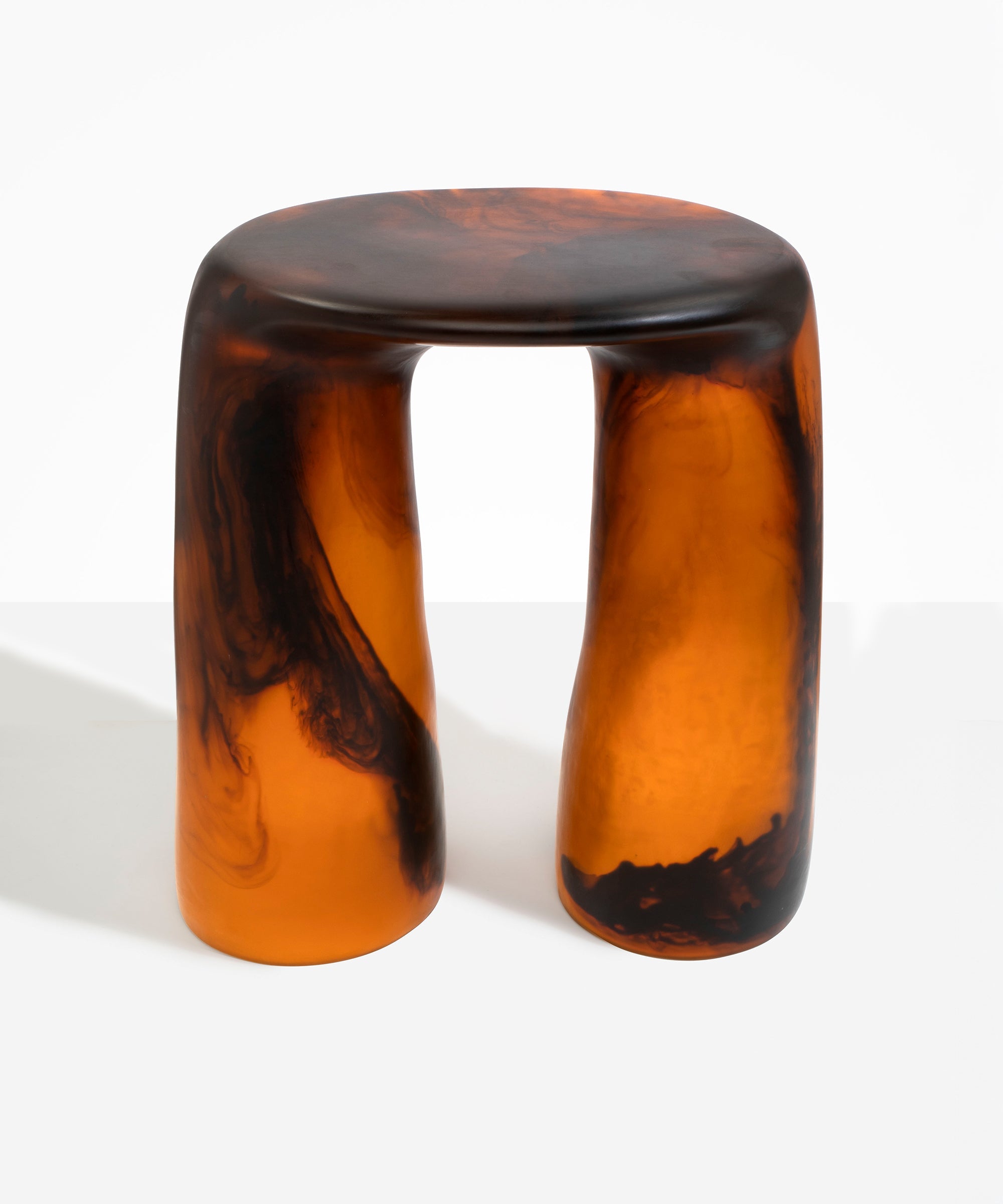 Dinosaur Designs Rock Tower Table in Tortoise — handcrafted marbled amber and black resin side table with oval top and two chunky rounded legs..