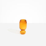 Dinosaur Designs Small Glass Rockpool Vase in Amber — handblown amber glass vase with rounded bulbous body and small spherical pedestal base..
