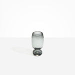 Dinosaur Designs Small Glass Rockpool Vase in Clear Black — handblown transparent black glass vase with rounded bulbous body and small spherical pedestal base..