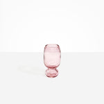 Dinosaur Designs Small Glass Rockpool Vase in Pink — handblown transparent pink glass vase with rounded bulbous body and small spherical pedestal base..