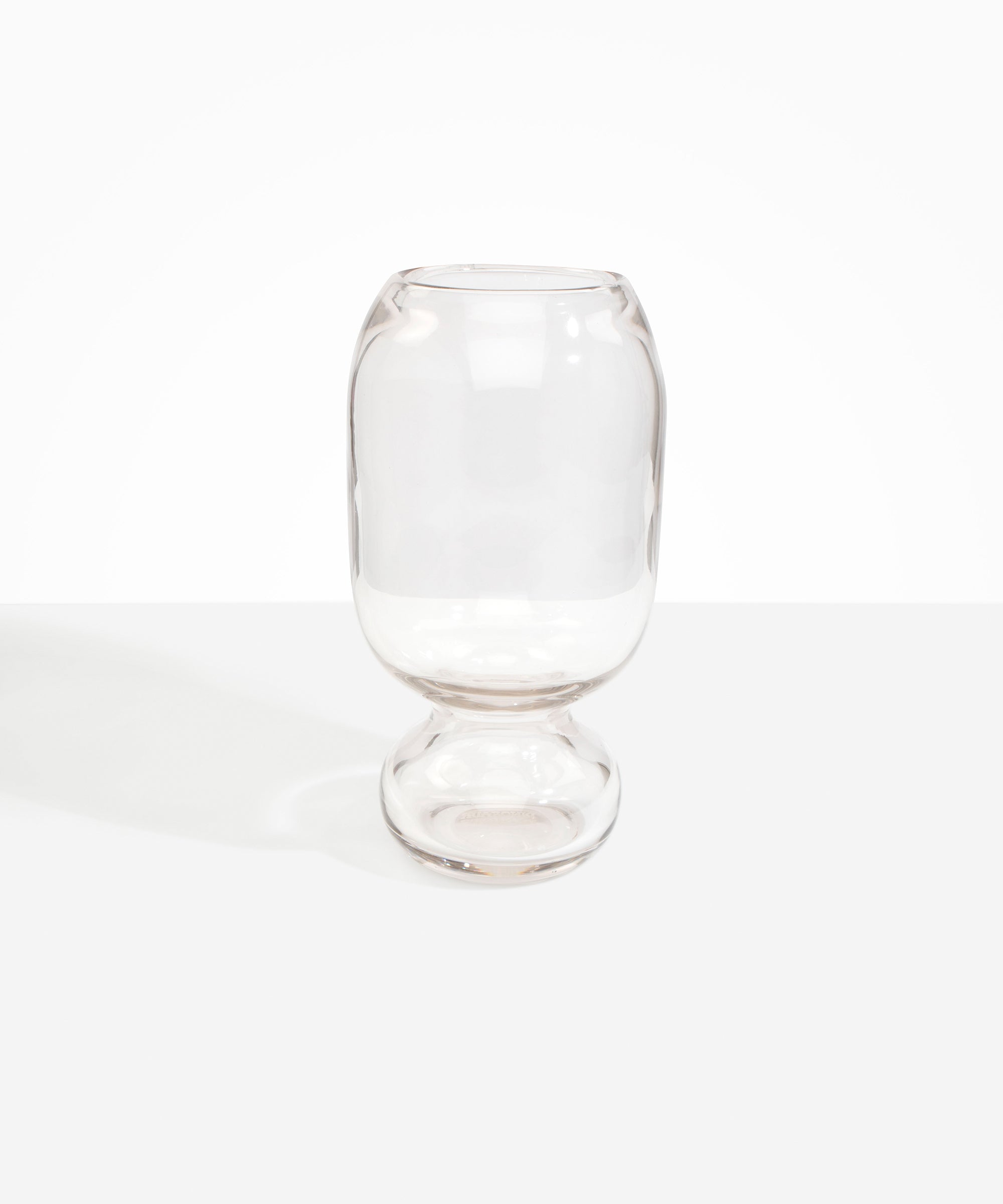 Dinosaur Designs Tall Glass Rockpool Vase in Clear — handblown transparent glass vase with rounded bulbous body and spherical pedestal base..