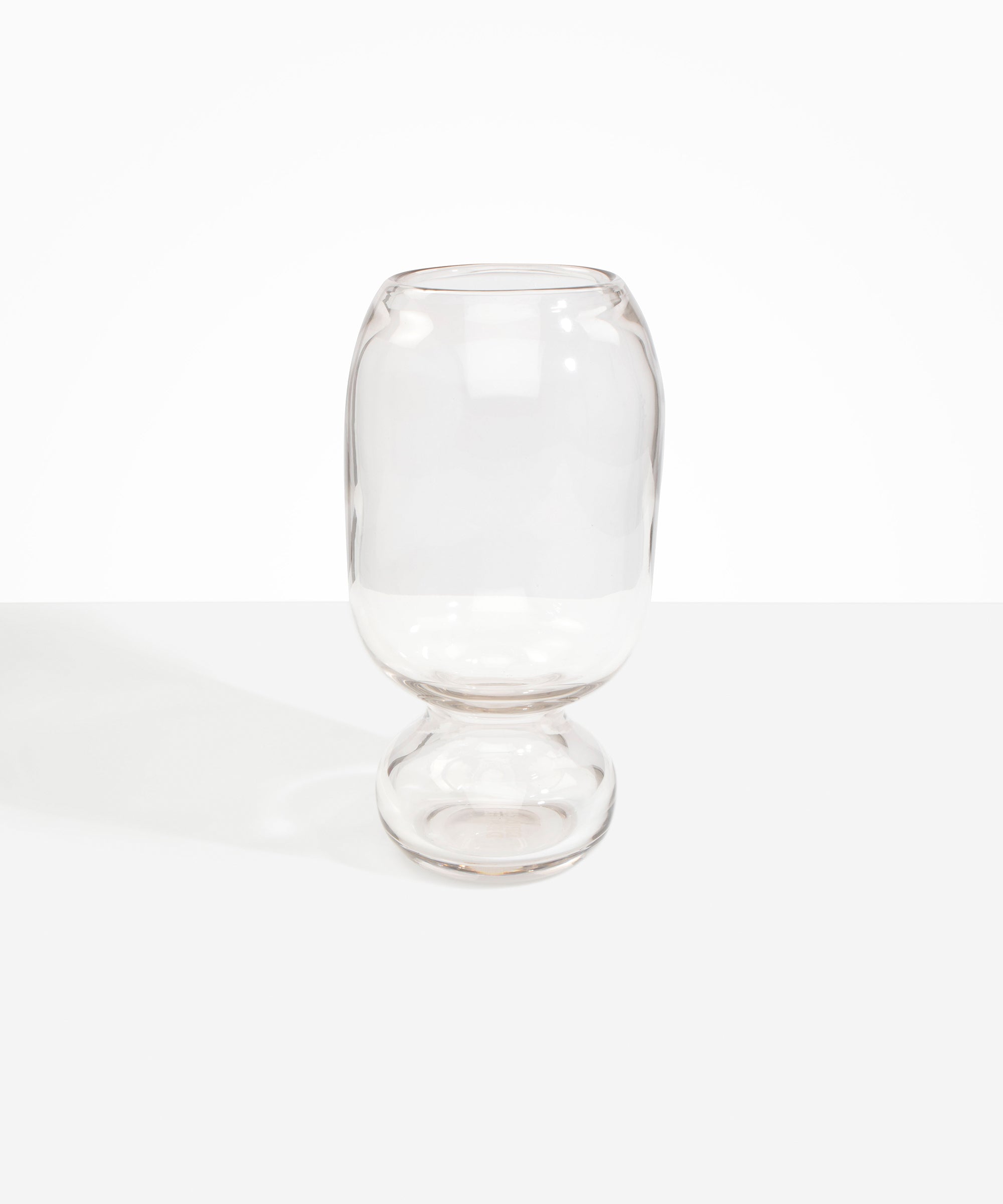 Dinosaur Designs Tall Glass Rockpool Vase in Clear — handblown transparent glass vase with rounded bulbous body and spherical pedestal base..