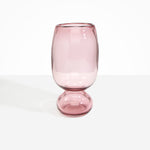 Dinosaur Designs Tall Glass Rockpool Vase in Pink — handblown transparent pink glass vase with rounded bulbous body and spherical pedestal base..