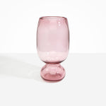 Dinosaur Designs Tall Glass Rockpool Vase in Pink — handblown transparent pink glass vase with rounded bulbous body and spherical pedestal base..