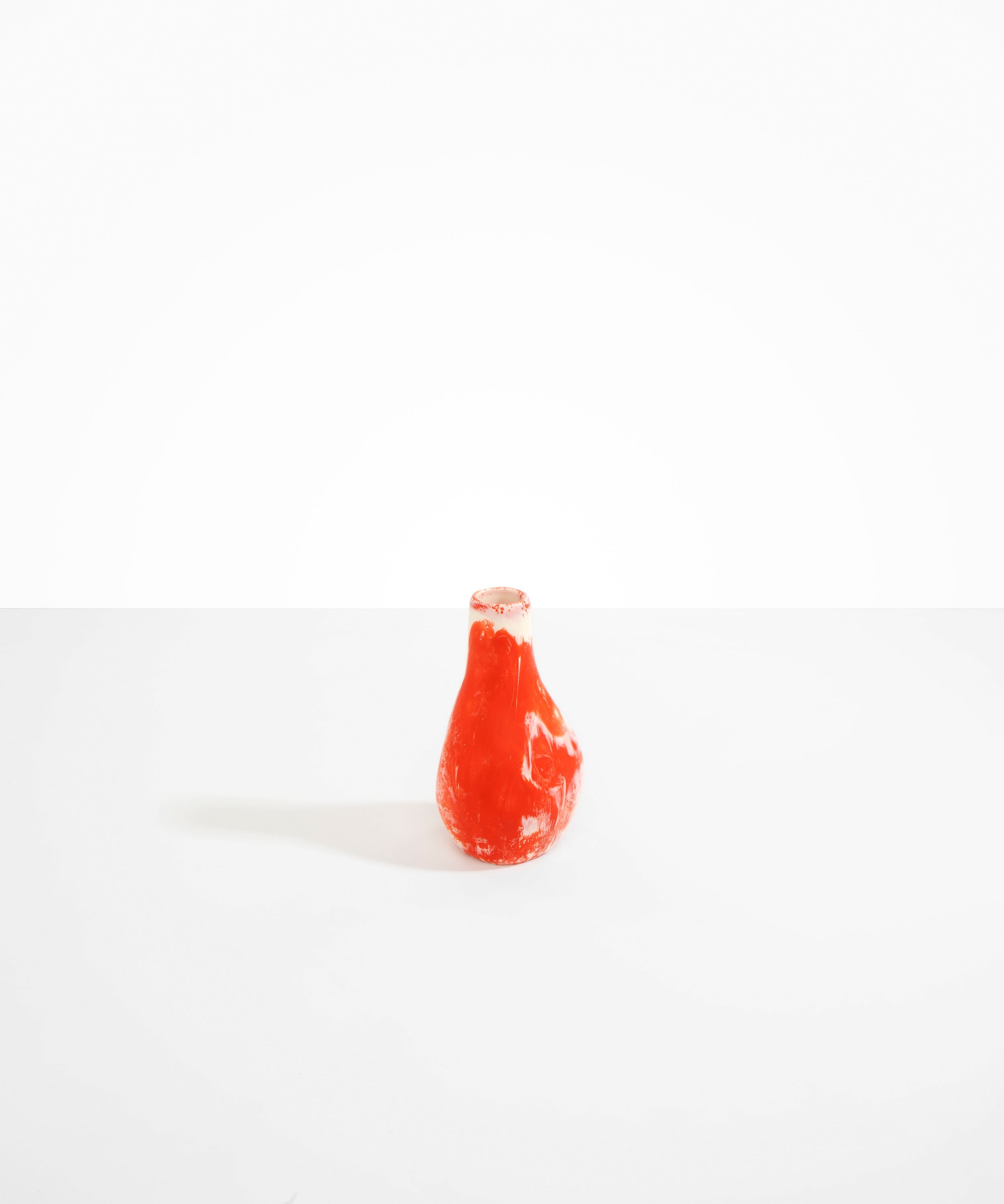 Dinosaur Designs medium sized Liquid vase in daisy red and cream colour resin..