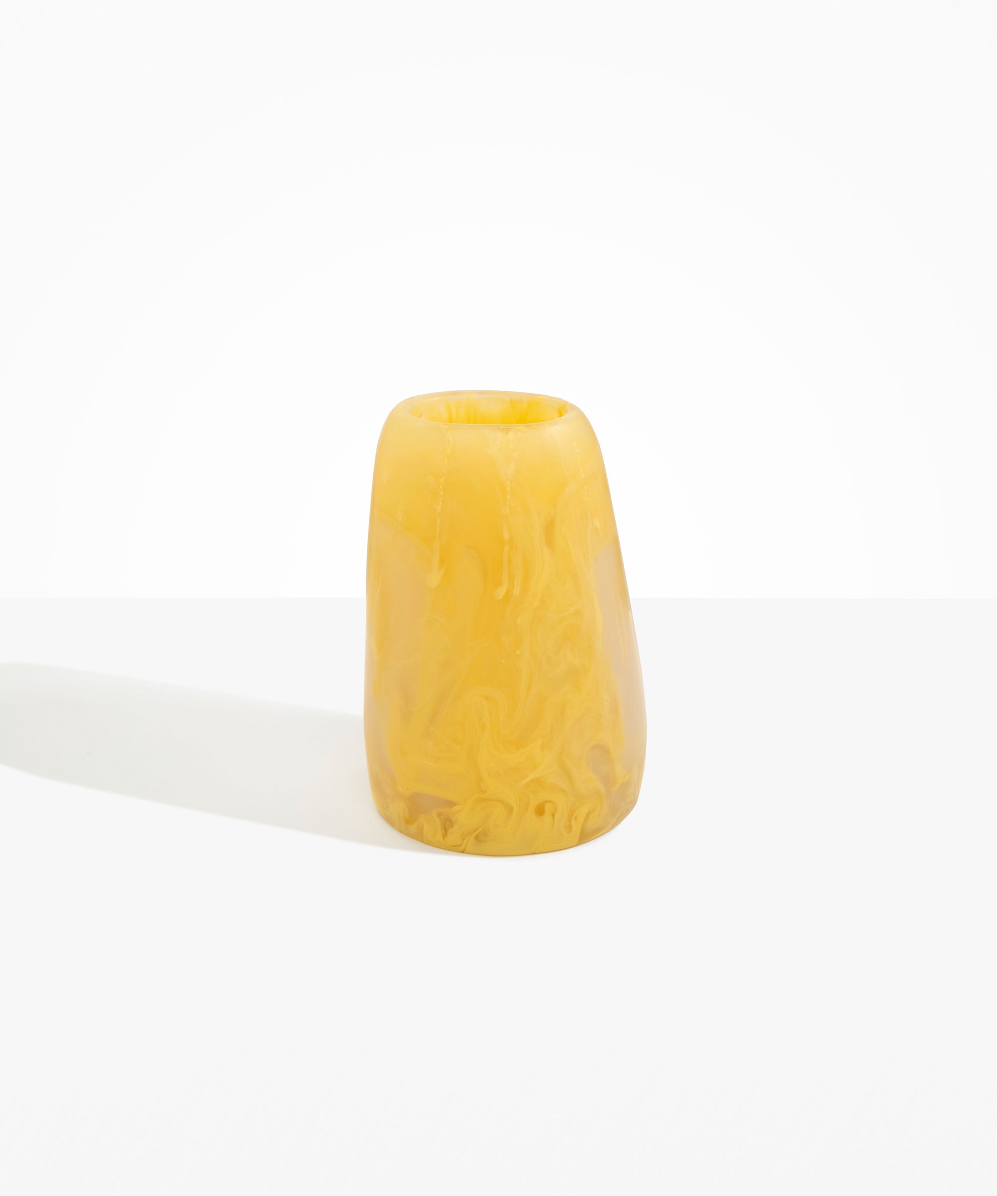 Dinosaur Designs Large Pebble Vase in Pollen — handcrafted marbled yellow and transparent resin vase with smooth rounded pebble form and narrow opening..