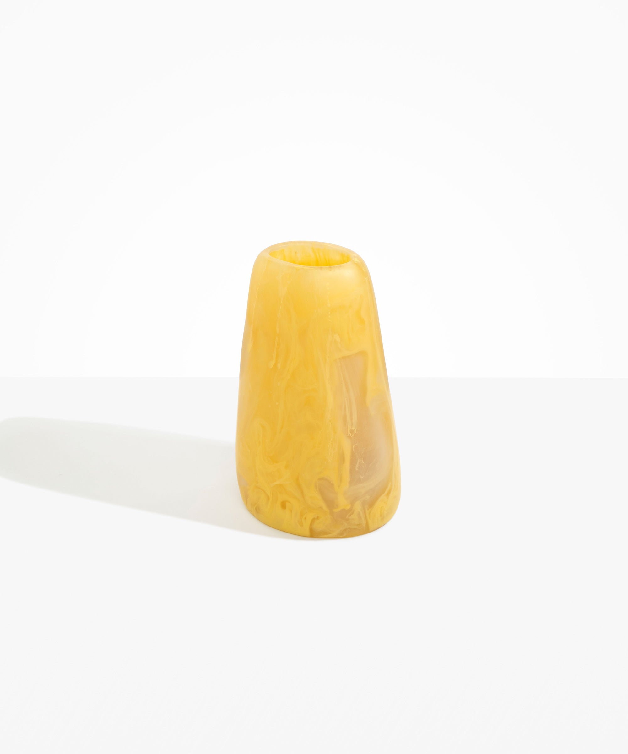 Dinosaur Designs Large Pebble Vase in Pollen — handcrafted marbled yellow and transparent resin vase with smooth rounded pebble form and narrow opening..
