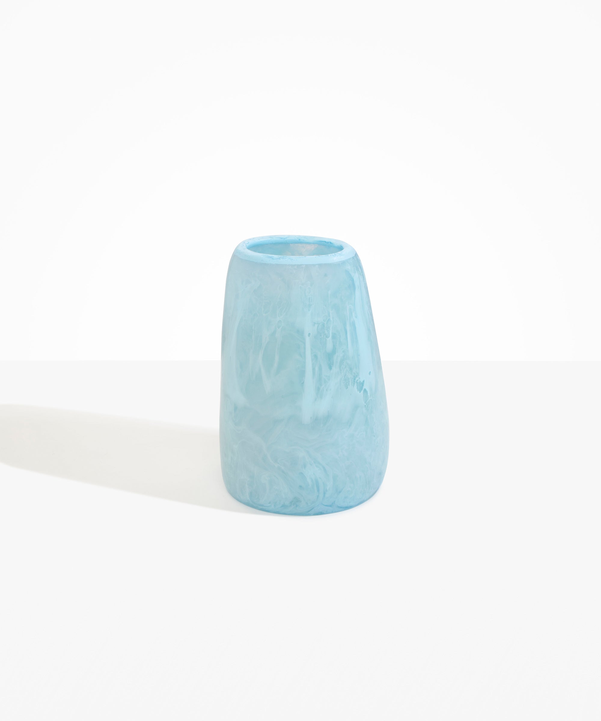 Dinosaur Designs Large Pebble Vase in Pool — handcrafted marbled blue and transparent resin vase with smooth rounded pebble form and narrow opening..