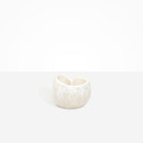 Dinosaur Designs Orchid Vase in Chalk Swirl — handcrafted marbled off-white resin vase with short rounded organic form and sculpted open petal-shaped rim