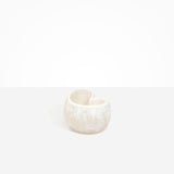 Dinosaur Designs Orchid Vase in Chalk Swirl — handcrafted marbled off-white resin vase with short rounded organic form and sculpted open petal-shaped rim