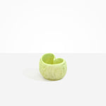 Dinosaur Designs Orchid Vase in Pistachio — handcrafted marbled pastel green resin vase with short rounded organic form and sculpted open petal-shaped rim