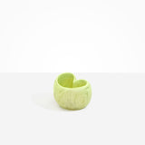 Dinosaur Designs Orchid Vase in Pistachio — handcrafted marbled pastel green resin vase with short rounded organic form and sculpted open petal-shaped rim