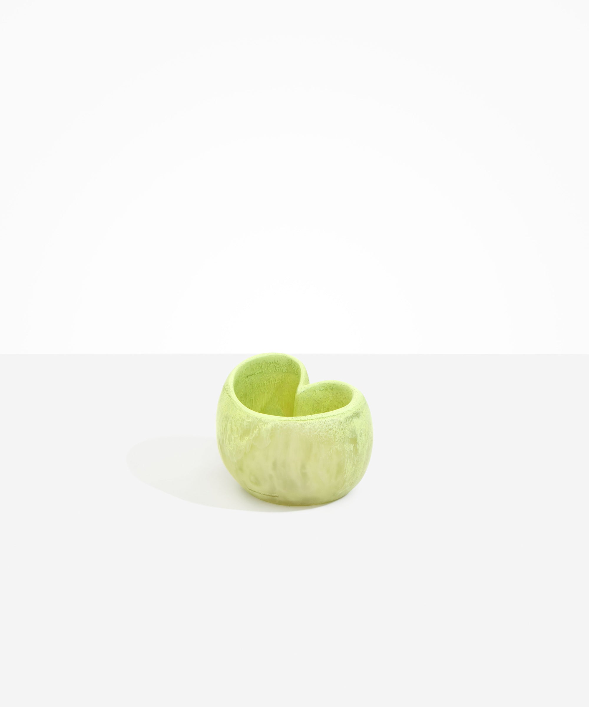 Dinosaur Designs Orchid Vase in Pistachio — handcrafted marbled pastel green resin vase with short rounded organic form and sculpted open petal-shaped rim