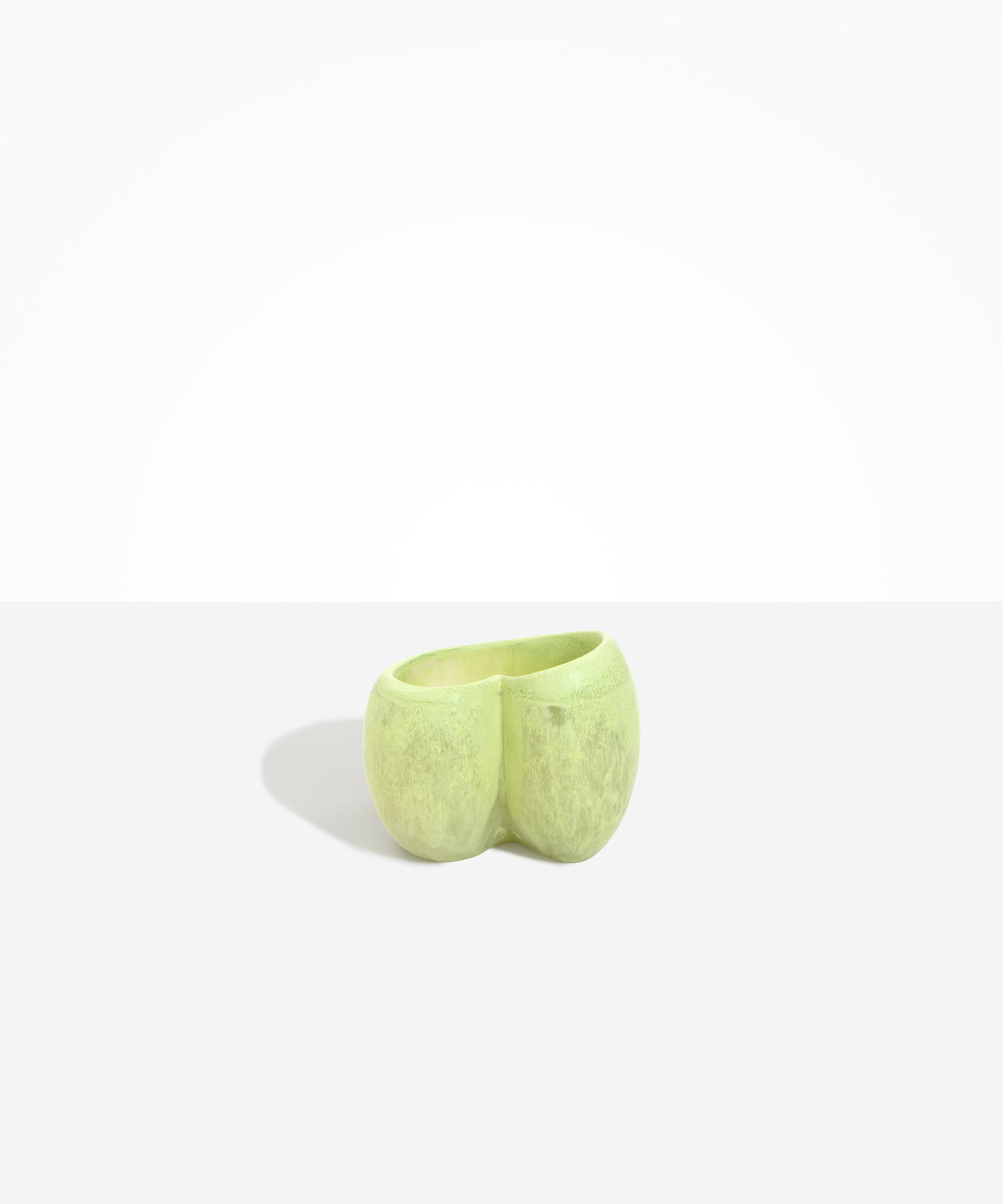 Dinosaur Designs Orchid Vase in Pistachio — handcrafted marbled pastel green resin vase with short rounded organic form and sculpted open petal-shaped rim