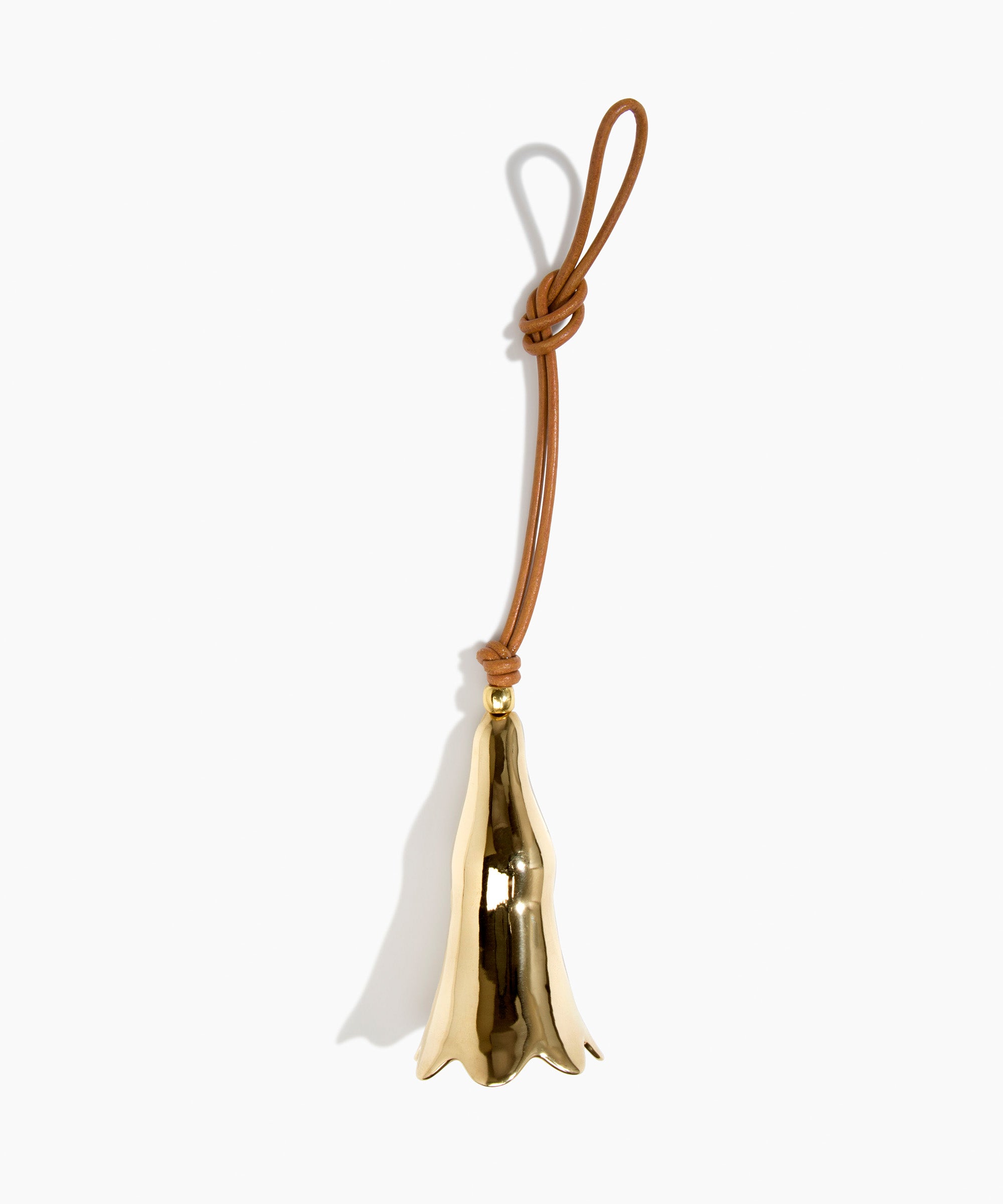 Dinosaur Designs Metal Long Flower Wind Chime in Brass — polished brass cast flower-shaped decorative wind chime with tan leather hanging loop