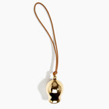 Dinosaur Designs Metal Gumnut Wind Chime in Brass — polished brass cast gumnut-shaped decorative wind chime with tan leather hanging loop