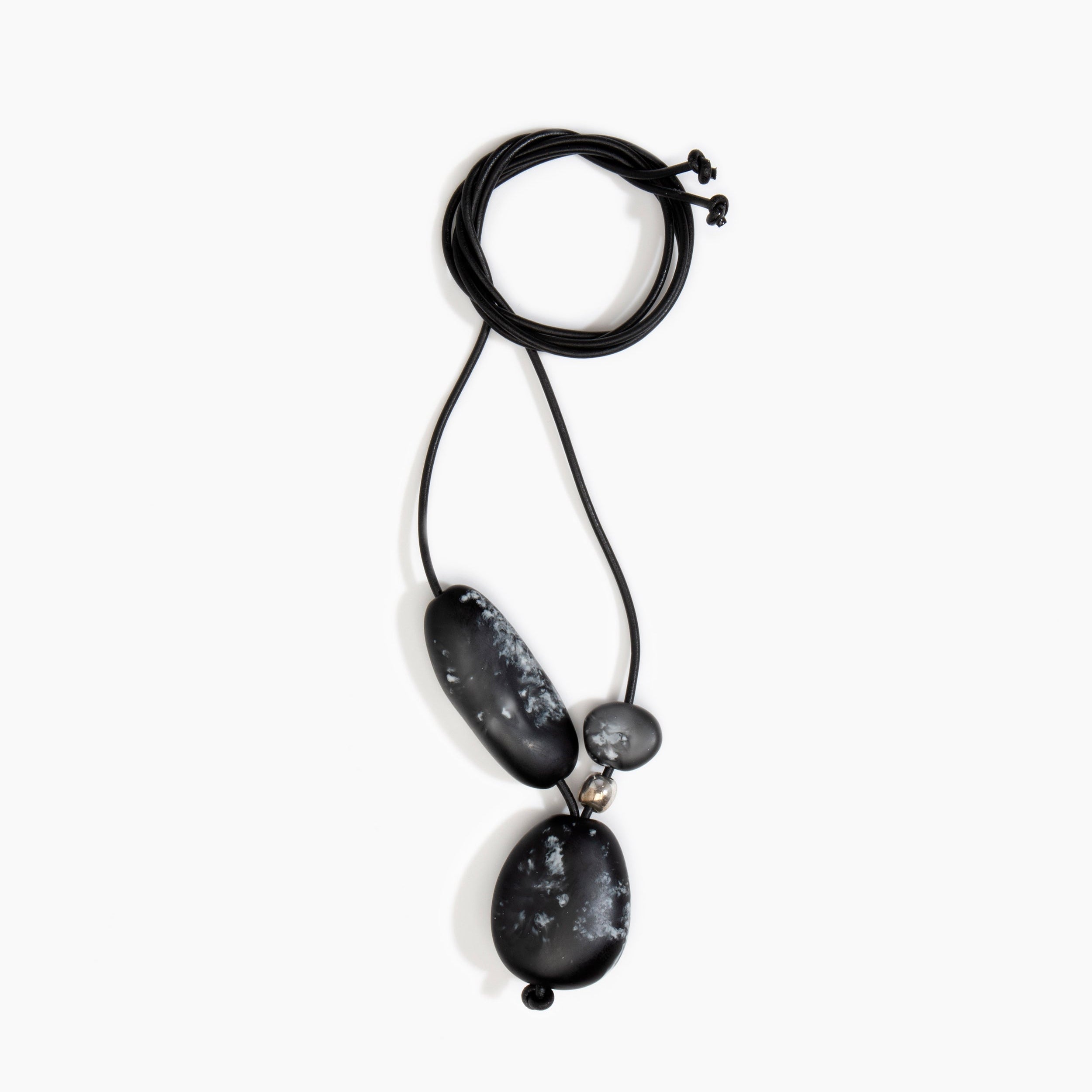 Dinosaur Designs Rock Cluster Pendant in Black Marble Colour resin with Nano-Coated Brass Bead Material.