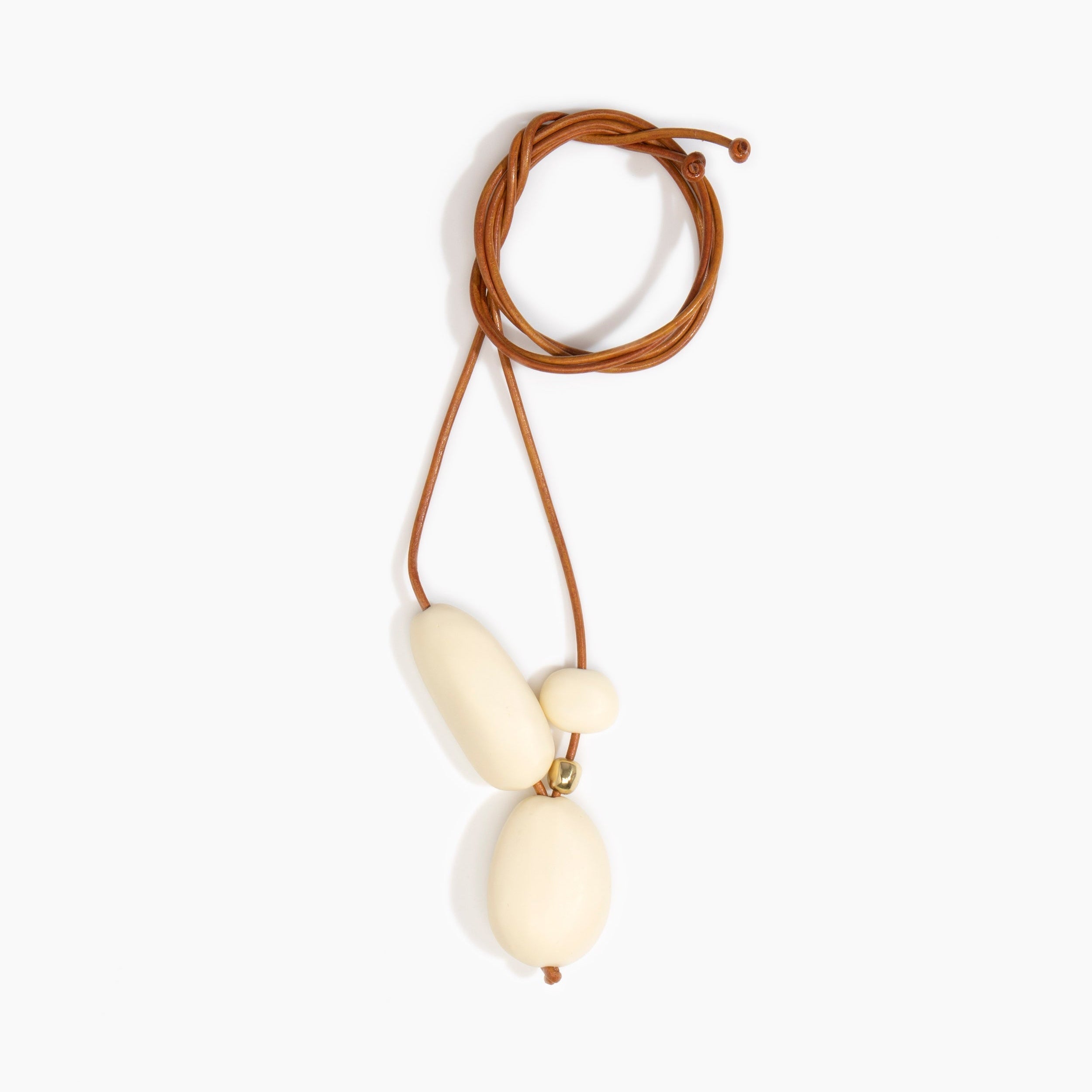 Dinosaur Designs Rock Cluster Pendant in Cream Colour resin with Nano-Coated Brass Bead Material.