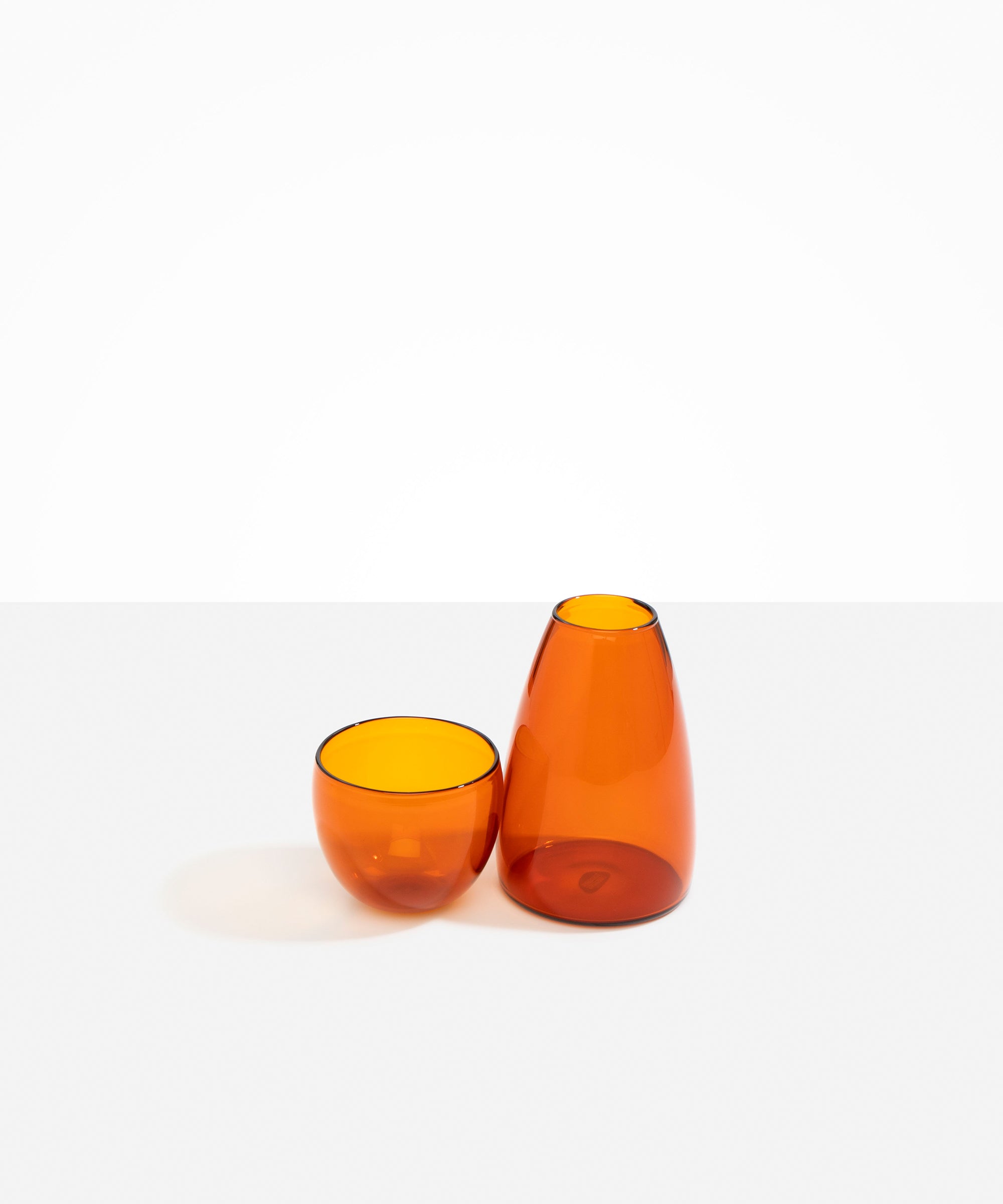 Dinosaur Designs coloured Glass Pebble Carafe cup and jug set in amber orange.