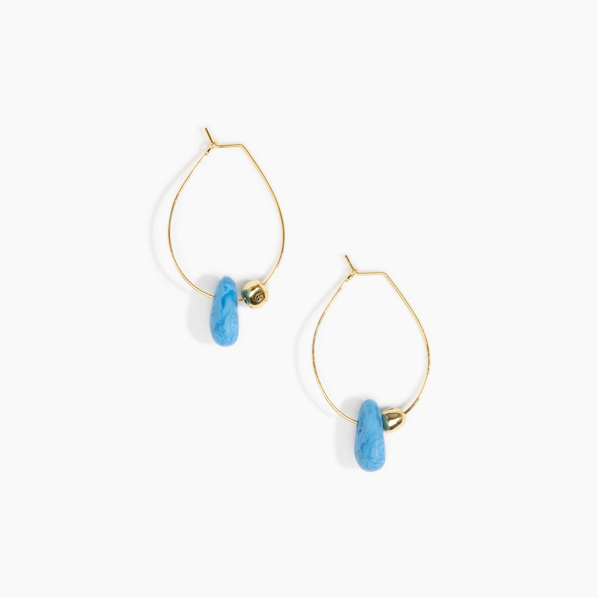 Dinosaur Designs Joie De Vivre Hoop Earrings in Sky Colour resin with Gold-Filled Material.